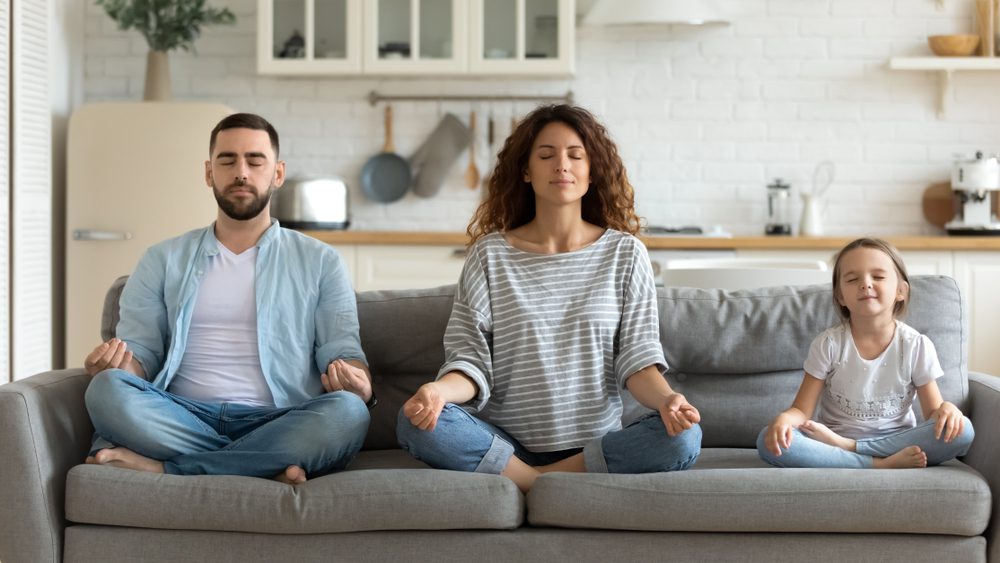 Family practicing meditation together