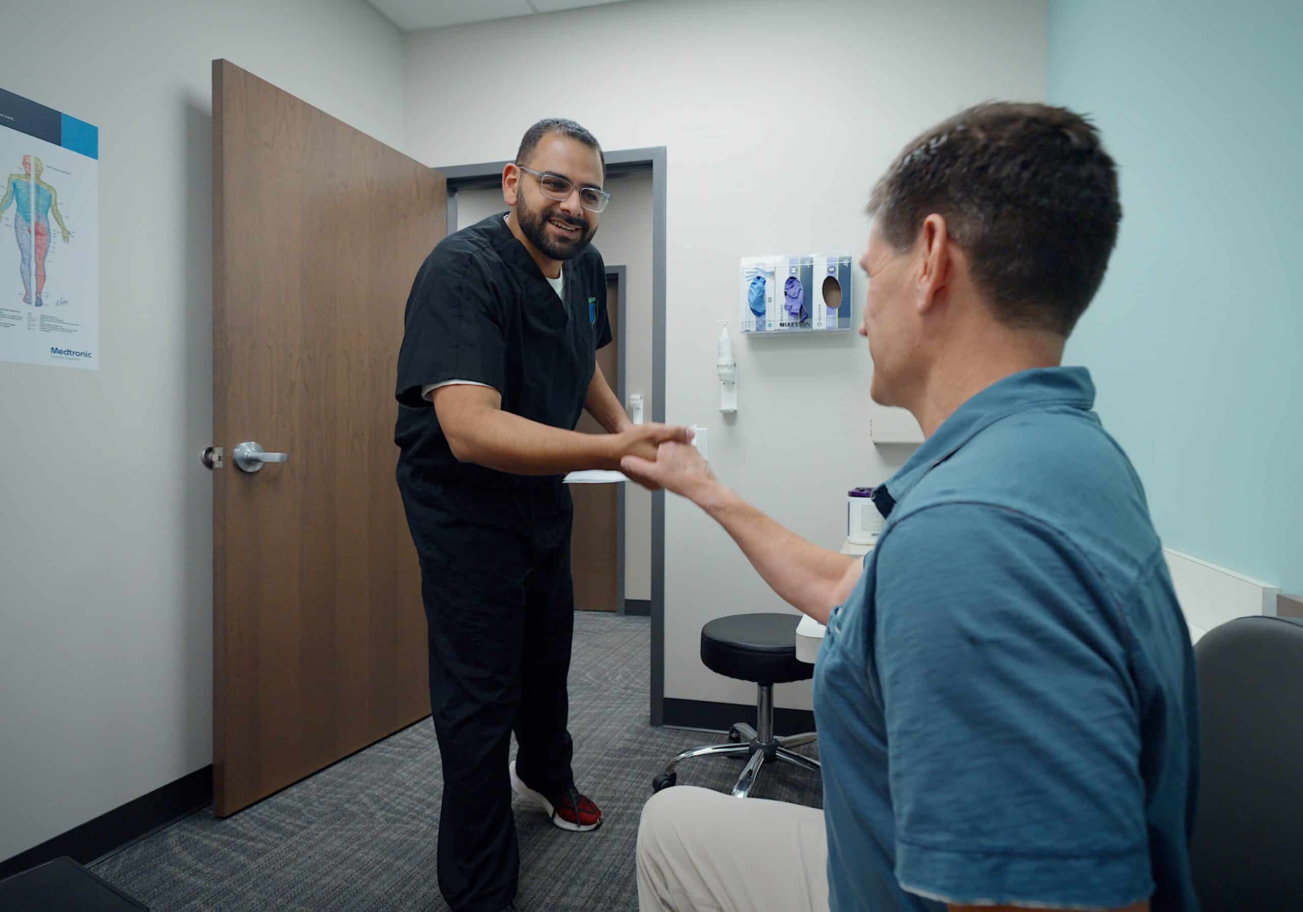 Dr Faltas meeting patient iSpine Clinics Dr Faltas iSpine Clinics meeting patient with chronic pain in Edina, Minnesota